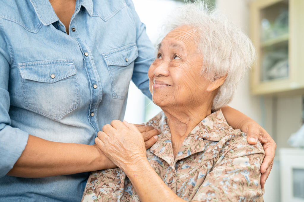 Caregiver help and care Asian senior woman patient with love, encourage and empathy in hospital.