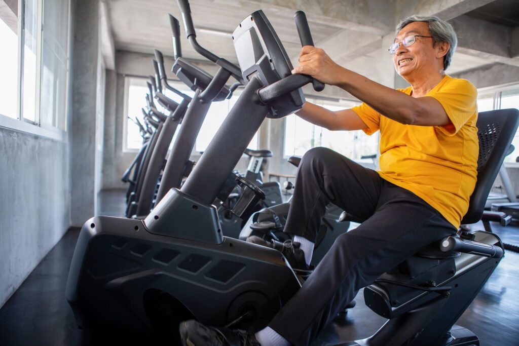 senior on stationary bike