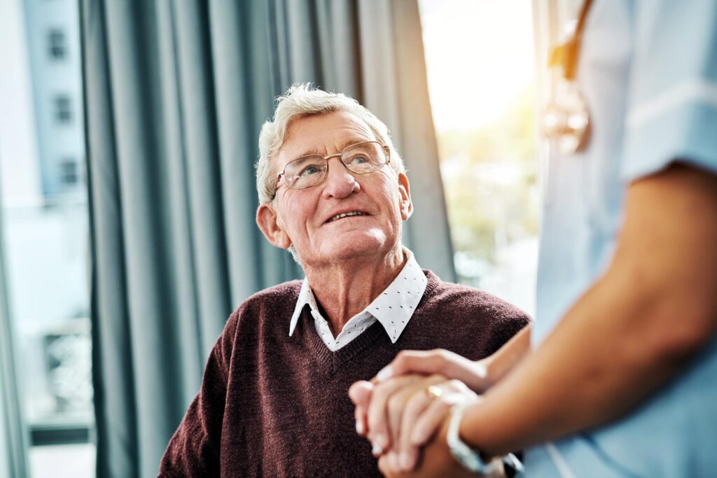 senior man holding the hand of doctor